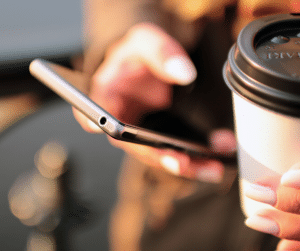 5 Reasons Your Business Needs Video Marketing in 2020 2 Lady holding smartphone with a cup of coffee.