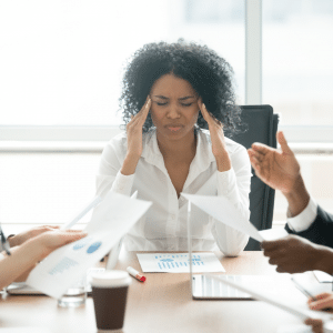 A lady getting overwhelmed in a meeting.